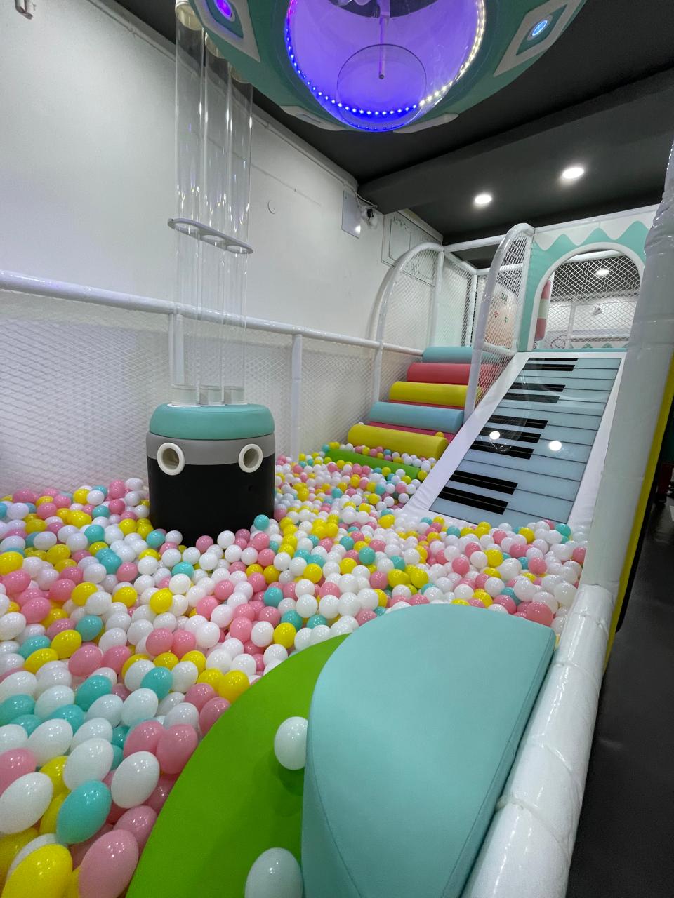 KOJO Patia ball pit with UFO light fixture and piano-key slide