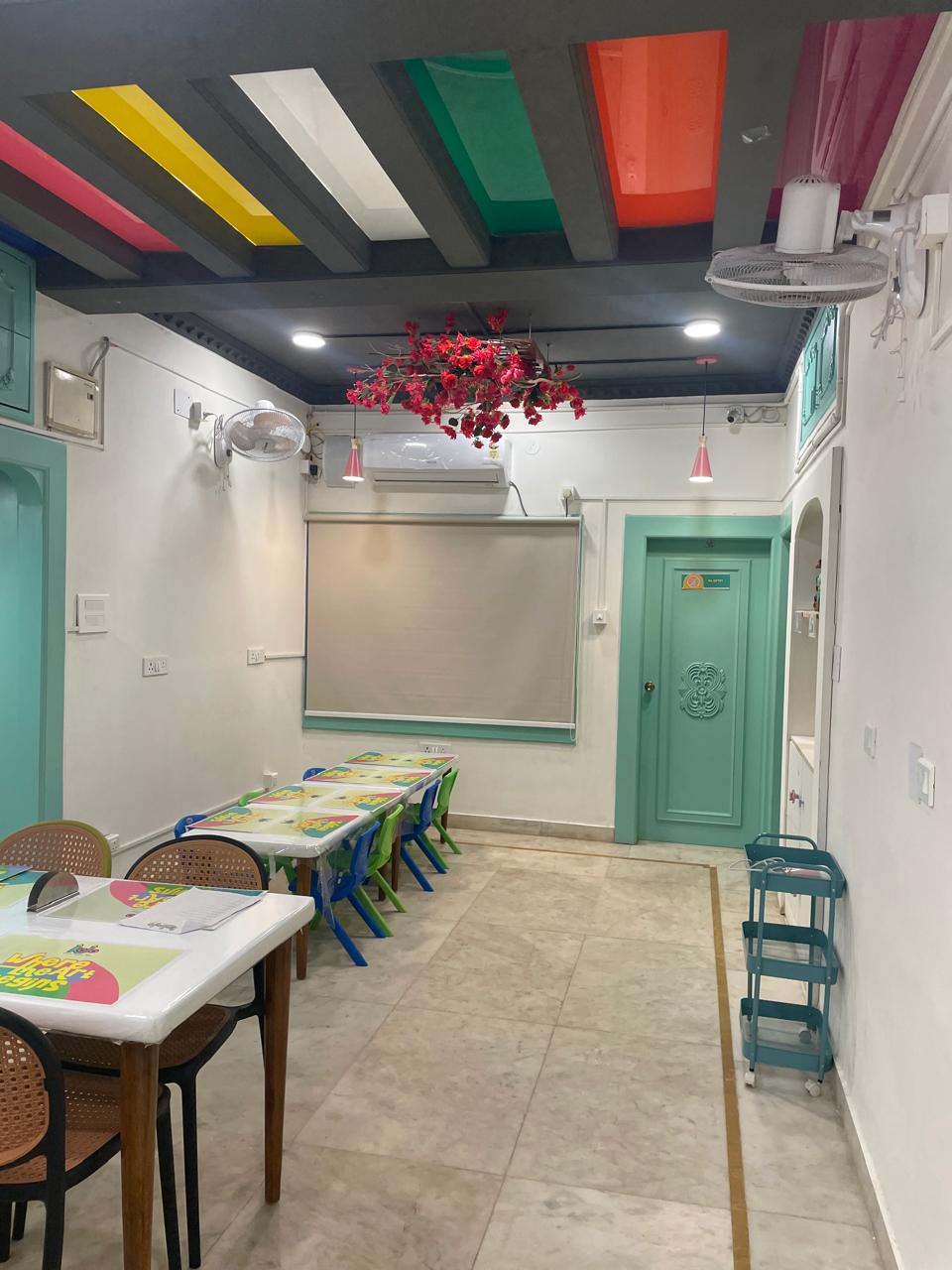 KOJO Art Café interior at Patia, with colour-blocked ceiling and bougainvillea