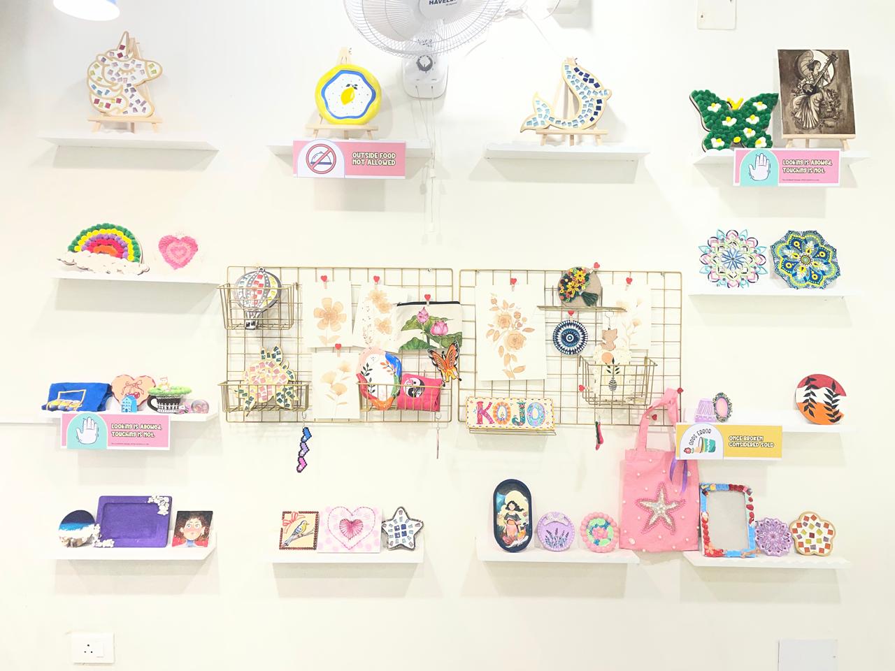 Wall of finished KOJO Art Menu crafts on display at Patia