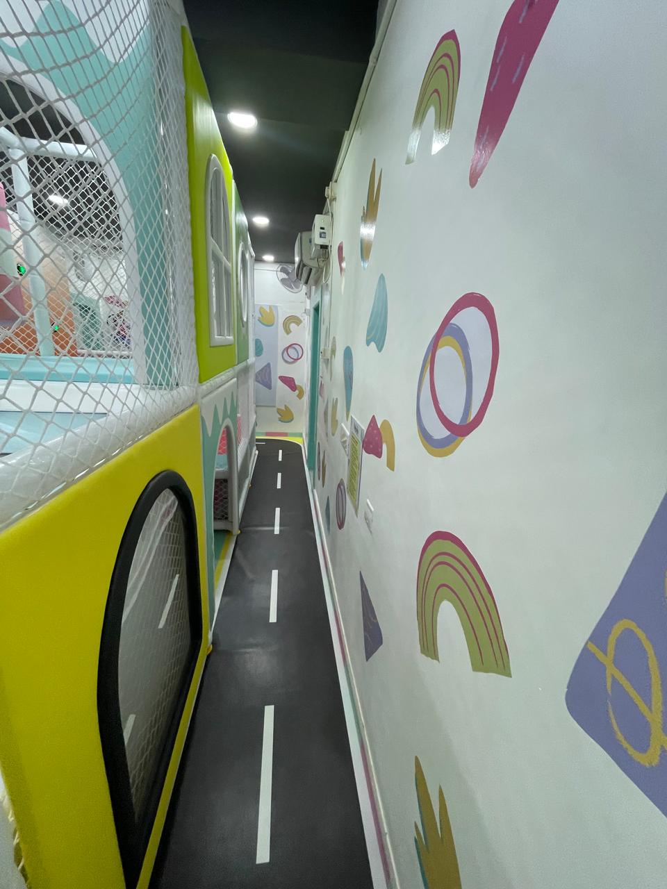 Netted play corridor with road-marked floor at KOJO Patia